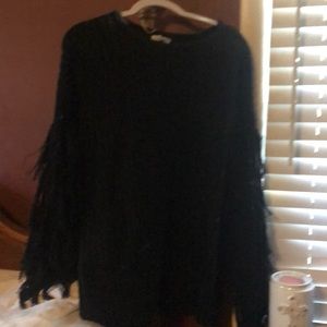 Black sweater with fringe on the arm